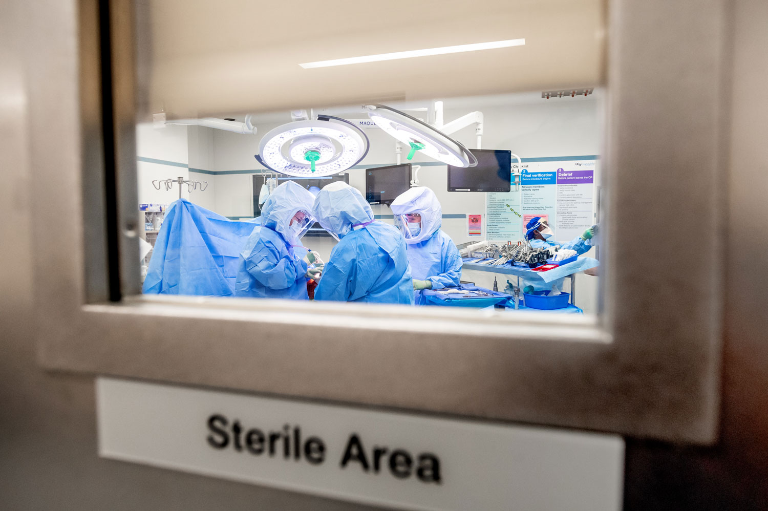Dr. Erdan Kayupov, left, and other surgeons perform a knee replacement surgery