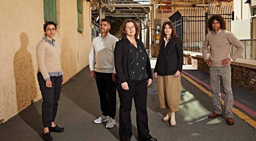 Photo of Amend director Brie Williams, MD (center), with San Quentin State Prison medical chief Alison Pachynski, MD ’02 (left), and Amend team members Fernando Murillo, Michele Casadei, and Daryl Norcott, JD.